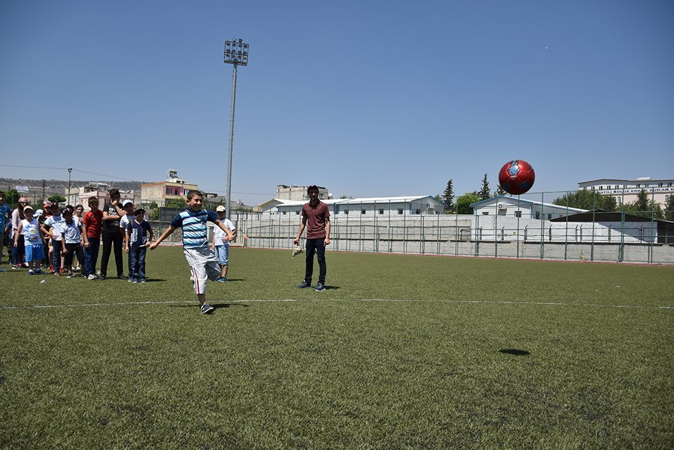 Kids get to play at the Kilis football stadium.